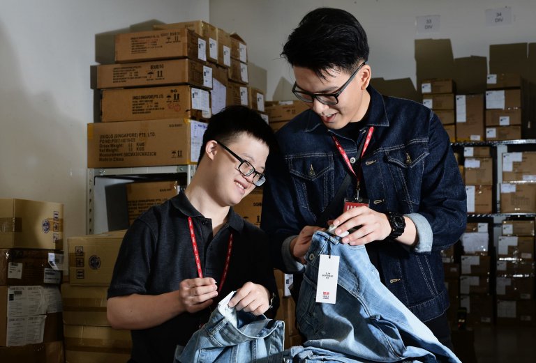 boy working at uniqlo tagging clothes