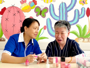 Yin Cho not only attends to the physical needs of residents, but also provides emotional support and companionship through simple activities such as painting their nails.